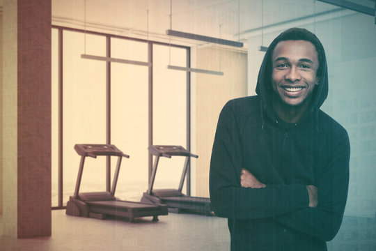 Two treadmills in a gray room corner, man