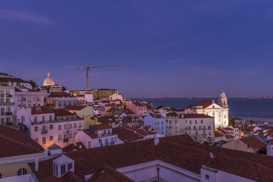 Lisbon Portugal. Beautiful timelapse from sunset to evening above the historical district of Alfama.