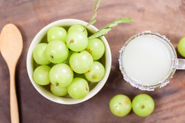 Top view of Indian gooseberry fruit and juice on wooden background,healthy food