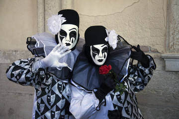 Venice Carnival figures dressed in comtumes and masks for the yearly festival
