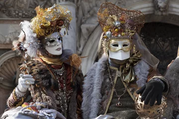 Fototapeten Venice Carnival characters in a colorful brown and gold Carnival costumes and masks Venice Italy © Alex Donnelly