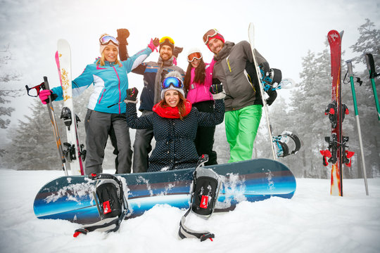 friends skiers and snowboarders having fun on snowbound winter forest