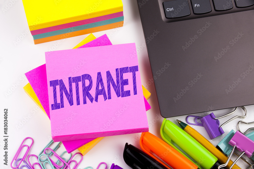 Poster writing text showing intranet word cloud made in the office with surroundings such as laptop, marker