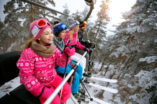 Skiing, ski lift, winter - girl skiers on ski lift at mountain