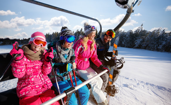 Skiing, ski lift, winter - skiers on ski lift at mountain