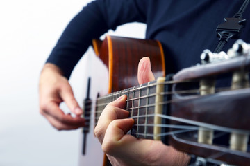 hands of the musician playing on classical guitar
