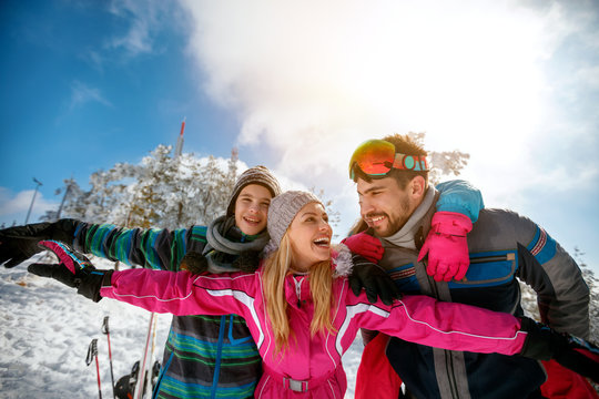 Family laughing and enjoying in winter vacations together on the mountain