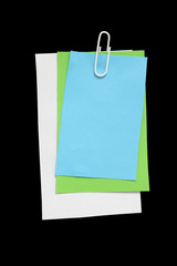 Pieces of white note paper with paperclip on a black background. copy space