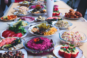 Beautifully decorated catering banquet table with different food snacks and appetizers assortment on corporate christmas party event celebration