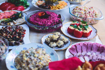 Beautifully decorated catering banquet table with different food snacks and appetizers assortment on corporate christmas party event celebration