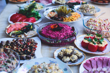 Beautifully decorated catering banquet table with different food snacks and appetizers assortment...