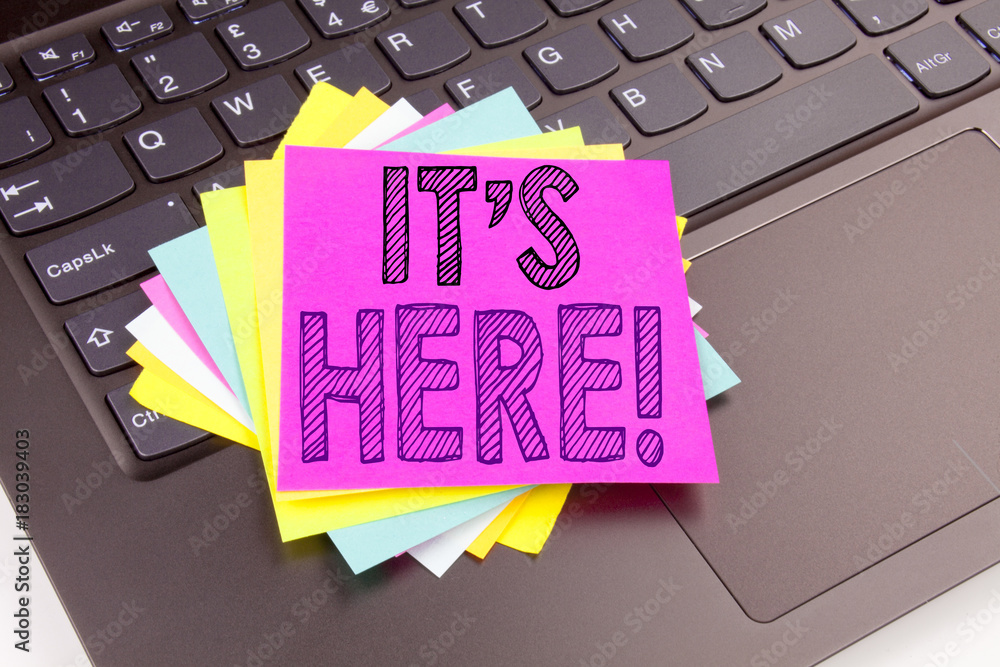 Poster writing it's here text made in the office close-up on laptop computer keyboard. business concept for