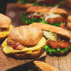 Beautifully decorated catering banquet table with different food snacks and appetizers with sandwich, on corporate christmas birthday kids party event or wedding celebration