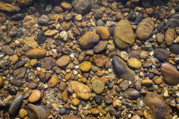 Beautiful natural color stone under clear river water, outdoor day light, nature concept