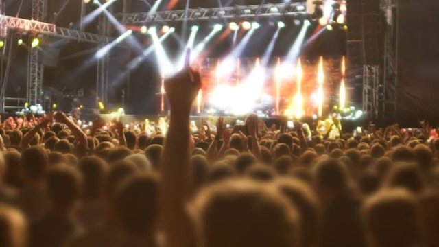 Enthusiastic crowd hanging out jumping and singing to music of favorite deejay