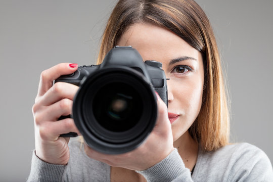 woman with DSLR taking a photograph