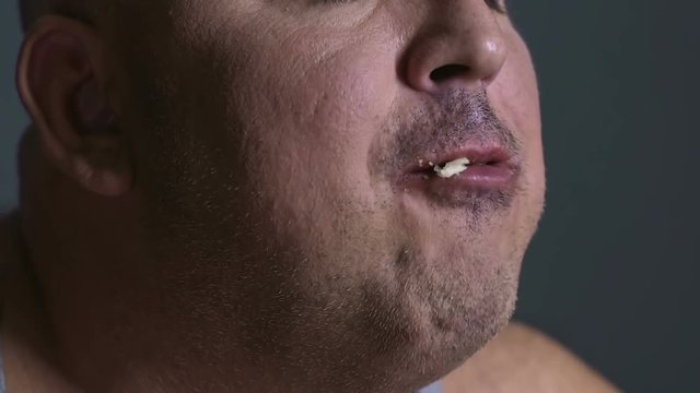 Fat man chewing food delightfully, inability to control junk food consumption