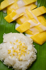 Sticky rice mango ,Thai dessert on banana leaf wooden table