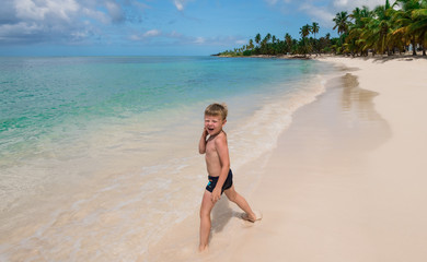 one little boy on a tropical beach