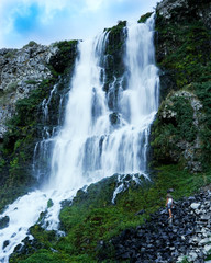 Lemmon Falls, Hagerman, Idaho with man hiking up to it. 