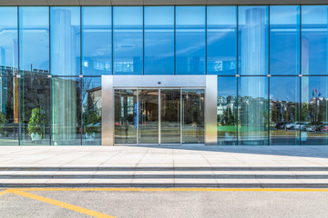 empty pavement front of the modern office entrance.