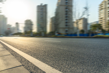 city empty traffic road with cityscape in background.