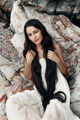 beautiful young boho style woman in white dress