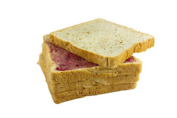 Whole wheat bread stack with grape jam on isolated white background.