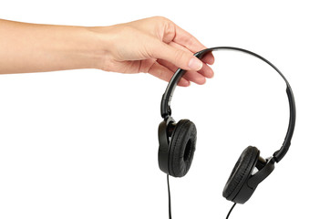 Black headphones in hand isolated on white background