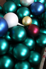 Factory of Christmas toys. The worker blows out the glass. The burner melts the glass. Decoration of a Christmas tree toy. Handmade. Manufacture of fur-tree toys. Many beautiful glass beads.