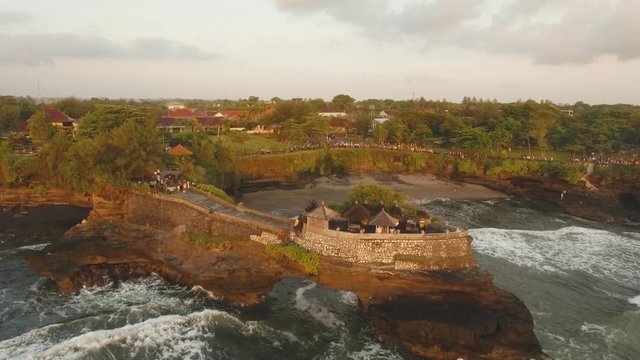 Aerial view of Traditional Hindu temple Tanah Lot Bali, Uluwatu, Indonesia. Balinese Hindu Temple, old hindu architecture, Bali Architecture, Ancient design. 4K video. Travel concept. Aerial footage.