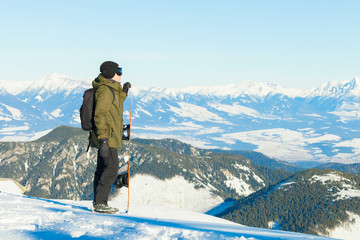 Naklejka na ściany i meble Snowboarder at the top of a mountain