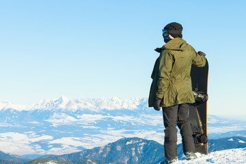 Fototapeta na wymiar Snowboarder at the top of a mountain