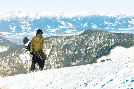 Snowboarder at the top of a mountain