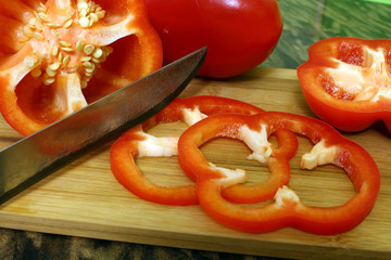 red sweet pepper and knife on chopping Board