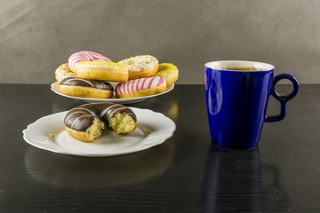 Bitten chocolate donut and a mug of coffee.