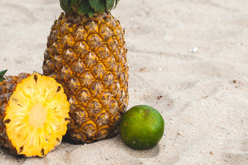 ripe juicy pineapple on the sand of a hot beach