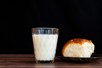 a glass of milk and a sweet bun