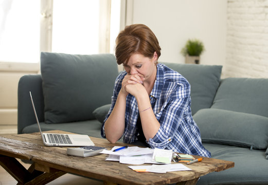 young sad worried and desperate woman banking and accounting home monthly and credit card expenses with computer laptop