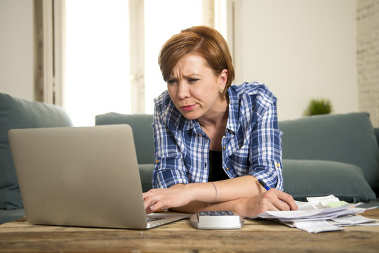 desperate woman banking and accounting home monthly and credit card expenses with computer laptop doing paperwork