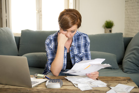 desperate woman banking and accounting home monthly and credit card expenses with computer laptop doing paperwork