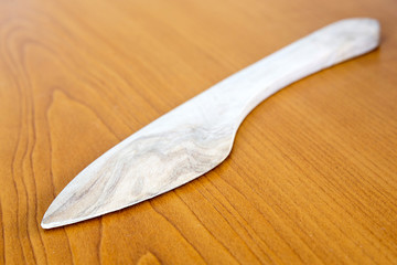 Wooden knife on wooden background