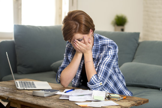 young sad worried and desperate woman banking and accounting home monthly and credit card expenses with computer laptop