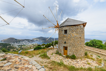 Windmill and beautiful aerial view of Skala village, Patmos island, Dodecanese, Greece