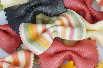 Beautiful colorful pasta in the shape of a butterfly isolated on white background. Striped pasta on a white background.