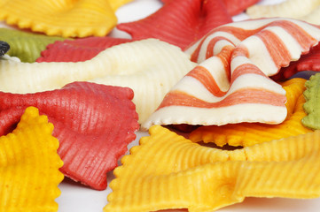 Beautiful colorful pasta in the shape of a butterfly isolated on white background. Striped pasta on a white background.