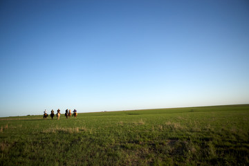 Group of cowboys on horseback
