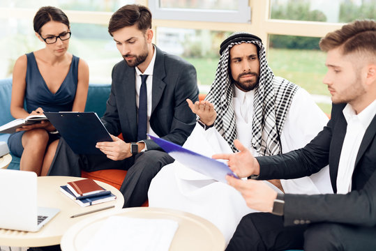 An arab businessman is discussing a business deal with his business partners.