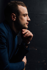 Close-up Studio portrait of young sexy man face hand-touch , holding chin, looking.