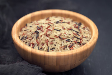 mix of white, brown and black rice in bowl